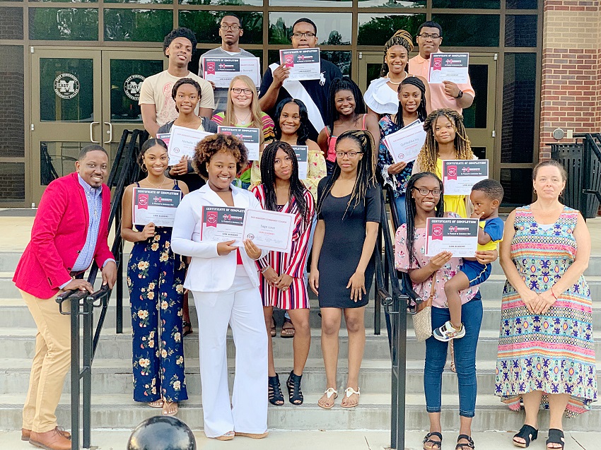 Dustin Atkinson, bottom far left, and Shannon Pendergrass, bottom far right, are instructors for East Mississippi Community College’s Lion Academy, which helps prepare high school students to take college courses. Atkinson and Pendergrass are pictured here with Lion Academy graduates during a June 27 ceremony on EMCC’s Scooba campus. Dustin Atkinson, bottom far left, and Shannon Pendergrass, bottom far right, are instructors for East Mississippi Community College’s Lion Academy, which helps prepare high school students to take college courses. Atkinson and Pendergrass are pictured here with Lion Academy graduates during a June 27 ceremony on EMCC’s Scooba campus.