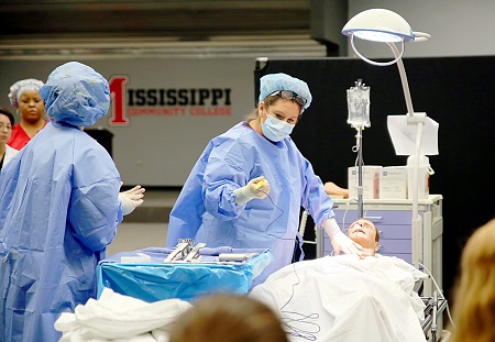 East Mississippi Community College Associate Degree Nursing instructor Karen Taylor, at right, plays the role of surgeon during a medical emergency simulation at the Golden Triangle campus in which students from all Division of Nursing and Allied Health programs participated. East Mississippi Community College Associate Degree Nursing instructor Karen Taylor, at right, plays the role of surgeon during a medical emergency simulation at the college's Golden Triangle campus in which students from all Division of Nursing and Allied Health programs participated.